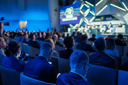 An audience seated for a technical session in a conference auditorium